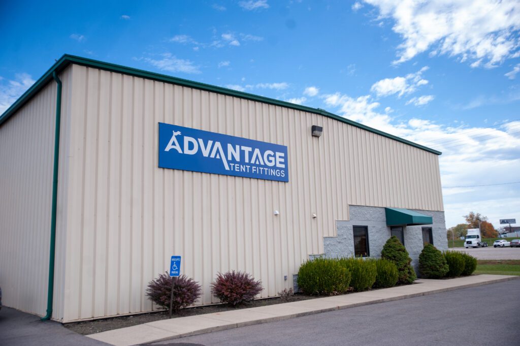 A metal pole building with a sign that reads "Advantage Tent Fittings"