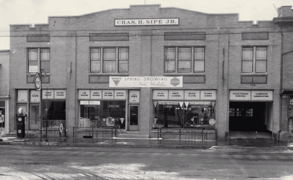 A black and white photo of a brick two-story building